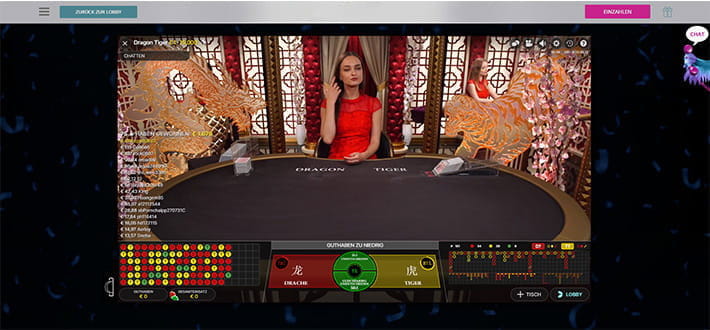 Ein Dragon Tiger Spieltisch mit einer Dealerin im Karmaba Live Casino.