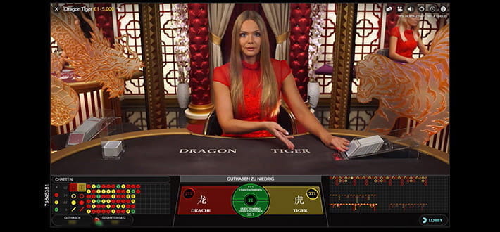 Ein Live Dragon Tiger Spieltisch von Evolution Gaming im Mega Casino. Der Dealer eröffnet die neue Spielrunde.