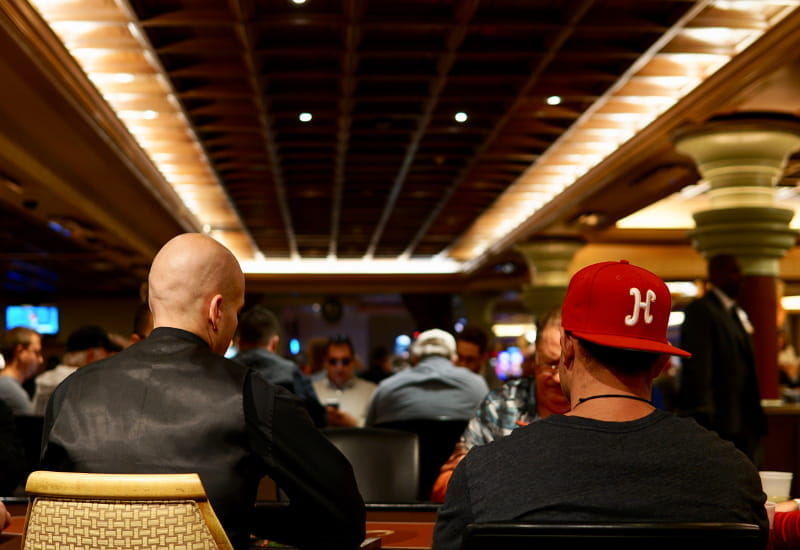 Pokerspieler an den Spieltischen eines Casinos.