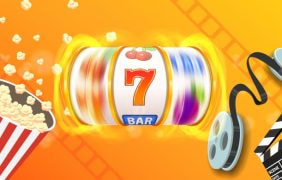 Eine Filmrolle mit Filmklappe und Slots Symbolen.