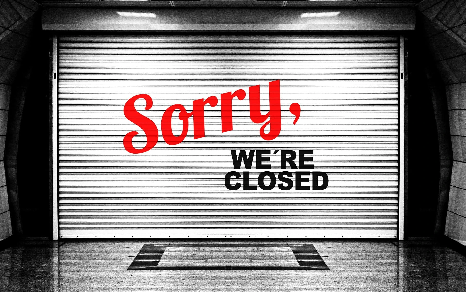 An einem Garagentor steht „Sorry, we’re closed“.