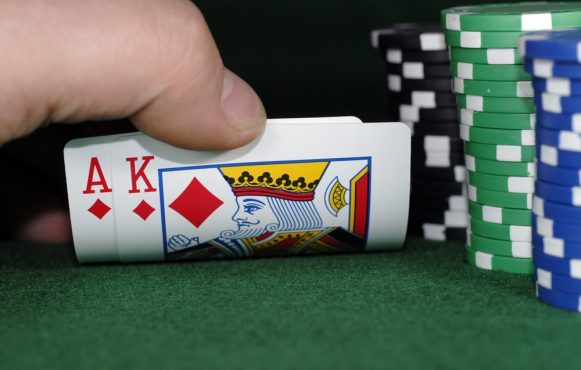 Pokerkarten und Pokerchips auf einem Pokertisch.