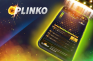 Das Wort 'Plinko' neben einem Smartphone, das aus einem Ufo gebeamt wird.